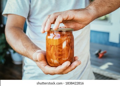 Jar Of Peach Jam In Men's Hands, Canning