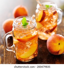 jar of peach tea with striped straw