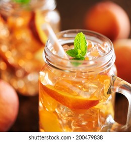 jar of peach tea with striped straw