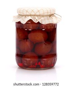 A jar of plum compote on white background
