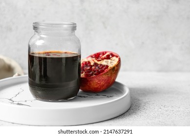 Jar Of Pomegranate Molasses On Light Background