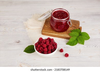 Jar of raspberry jam and fresh berries. Homemade jam
