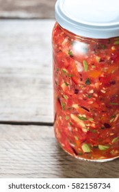 Jar Of Salsa On The Wooden Background