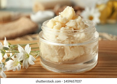 Jar with shea butter on table