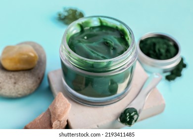 Jar Of Spirulina Facial Mask On Blue Background