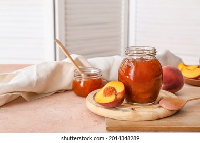 Jar With Tasty Peach Jam On Table