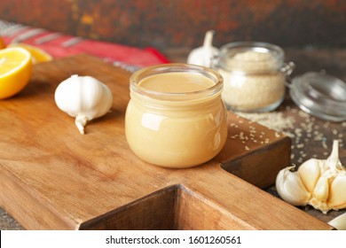 Jar Of Tasty Tahini On Wooden Board