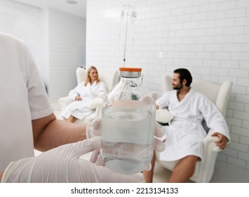 Jar With Vitamin Cocktail For Intravenous Therapy In Hands Of Healthcare Worker For Wellness Center Patients. Maintenance Of Human Immune System With Vitamin IV Infusion Therapy