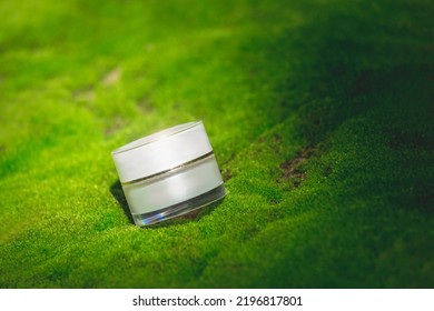 A Jar Of White Beauty Cream In A Container On Green Background. Cosmetic Package Mockup. Skin Cosmetic Product.