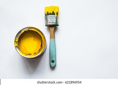 Jar With A Yellow Paint, On It Is A Brush, A White Background, A Place For A Signature