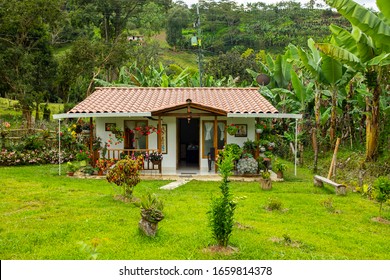 Jardin, Antioquia / Colombia - November 14 2019: Little and Picturesque House with many Flowers and Trees around, near to Coffee Plants Fields