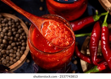 Jars of delicious homemade spicy chili sauce with fresh red chili peppers and peppercorns - Powered by Shutterstock