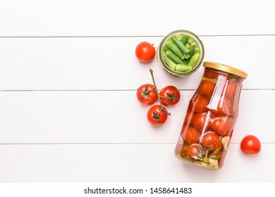 Jars With Different Canned Vegetables On White Wooden Background