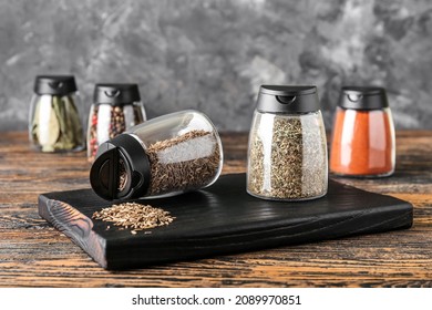 Jars with different spices on table