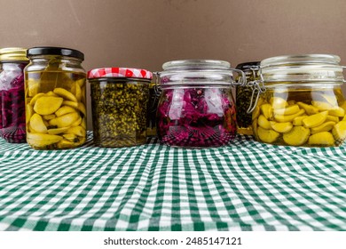 Jars of home made preserves, pickled red cabbage, confit of garlic and wild garlic  or ramson seed bud capers, landscape - Powered by Shutterstock