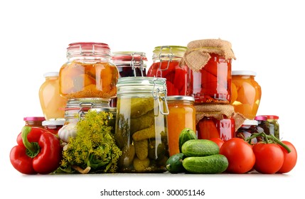 Jars with pickled vegetables and fruity compotes isolated on white background. Preserved food