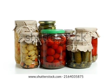 Jars of pickled vegetables isolated on white background
