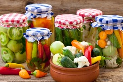 Jars With Pickles, Green Tomatoes, Cayenne Pepper, Mixed Salad And Chillies