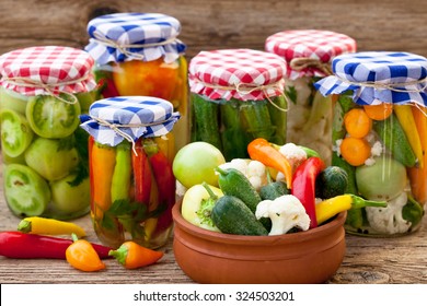 Jars with pickles, green tomatoes, cayenne pepper, mixed salad and chillies - Powered by Shutterstock