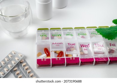 Jars Of Pills And Water. Pill Box With Pills For Morning And Evening. Open Pill Box With Pills Or Vitamins For Senior Patient