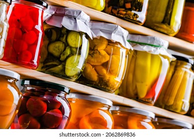 Jars with variety of marinated vegetables and fruits. Preserved food - Shutterstock ID 2062869836