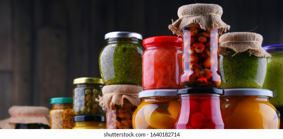 Jars with variety of pickled vegetables and fruits. Preserved food - Shutterstock ID 1640182714