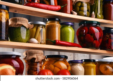 Jars with variety of pickled vegetables. Preserved food - Shutterstock ID 582906064