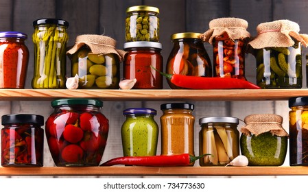 Jars with variety of pickled vegetables. Preserved food - Shutterstock ID 734773630