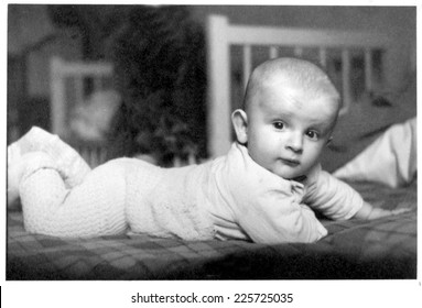 JASLO,POLAND - CIRCA 1950 : Vintage Photo Of Baby Boy In Bed