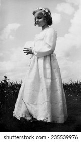 JASLO,POLAND - CIRCA 1952 :vintage Photo Of Girl Receiving Holy Communion Outdoor