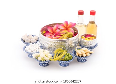 Jasmine garland and Colorful flower in water bowls decorating and scented water, perfume, marly limestone, pipe gun isolated on background for songkran festival or thai new year.