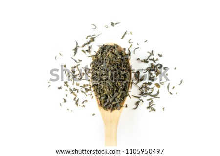 Jasmine green tea on wooden spoon over white background for hot or cold drinks, top view (flat lay), fresh whole loose leaves, floral flavour for fine aroma beverage enjoyment during tea time or meal