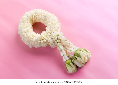Jasmine and white rose garland. Songkran Festival in Thailand on a pink pastel background. Traditional of Thai.