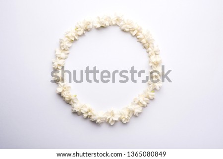 Jasminum sambac or Mogra Flower arranged in a  circular or rectangular  frame shape over white background, selective focus