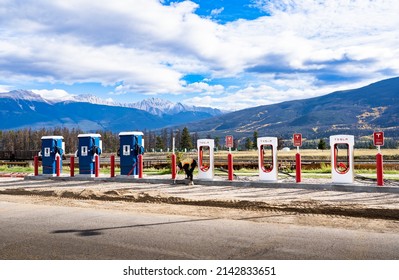 Jasper Alberta Canada, September 27 2021: Electric Vehicle charging stations being installed by a construction worker along a roadway.