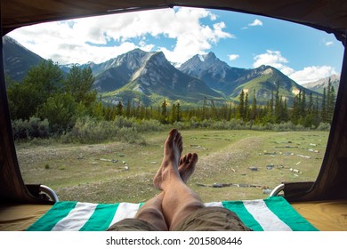 JASPER, ALBERTA CANADA: Traveler Sticks Feet Outside of Pop Up Tent Looking Into Incredible Wilderness