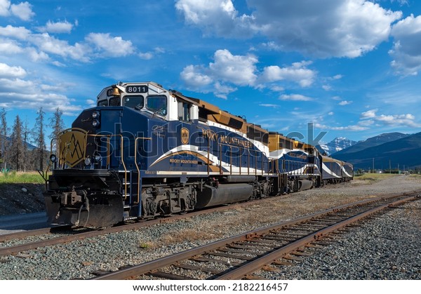 JASPER, CANADA - JULY 23, 2022: Rocky\
Mountaineer train locomotive with wagons on the railroad tracks of\
Jasper train station in\
Alberta.