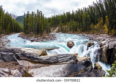  Jasper National Park, Canada. Small Island In The Middle Of The River. The Concept Of Extreme And Ecological Tourism. The Waterfall Rushes To The Rocky Shores