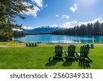 Jasper National Park summer landscape, Alberta, Canada. Adirondack chairs on lakeside of the Beauvert Lake (Lac Beauvert). Snowcapped Whistlers Peak mountain in the background.