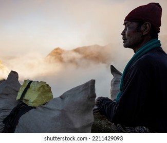 Java Ijen Indonesian Male Manual Worker With Basket Cradle And Sulphur Blocks From Volcano Rim Indonesia South East Asia