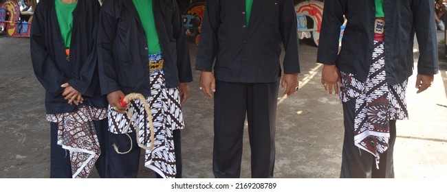 Javanese men wearing traditional costume: batik. Selective focus.