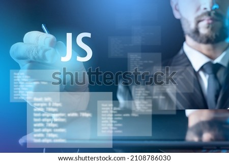 Javascript Development of programs. JS label on virtual screen. Businessman reaches for javascript button. Software development business concept. Business development with javascript.