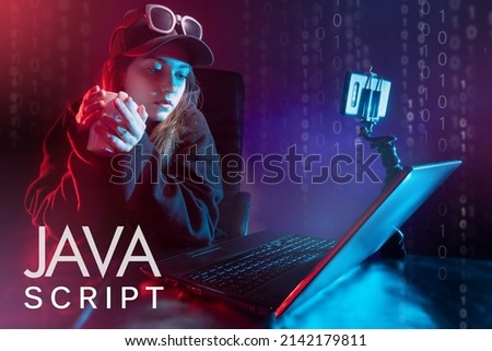 Javascript programming. Female programmer next to the computer. Javascript logo in the foreground. Writing code in Javascript. Java programming language courses. Software developer.