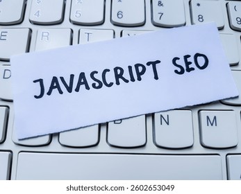 Javascript seo writting on laptop keyboard background.