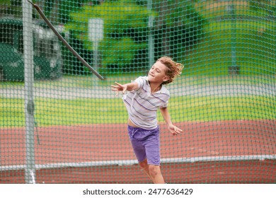 Javelin throw competition for kids. Athletics club training in school. Little boy throwing javelin on school stadium. Young athlete exercising. Healthy sport outdoor. - Powered by Shutterstock