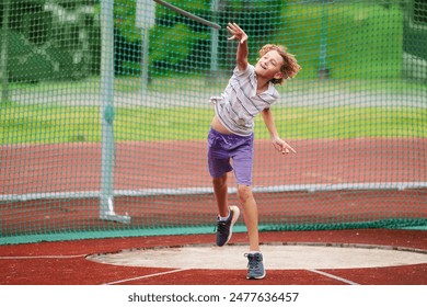 Javelin throw competition for kids. Athletics club training in school. Little boy throwing javelin on school stadium. Young athlete exercising. Healthy sport outdoor. - Powered by Shutterstock