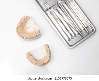 jaw impression with dental instrument on white backgroung - Shutterstock ID 2135978073