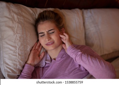 Jaw pain after sleeping, bruxisum TMJ teeth clenching  - Shutterstock ID 1538855759