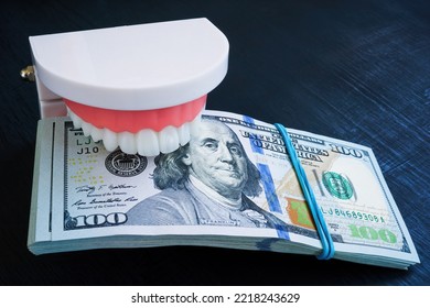 Jaws Holding A Stack Of Banknotes. Dental Insurance Concept.