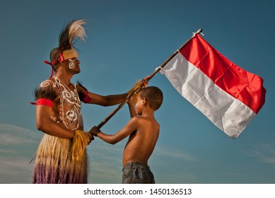jayapura Papua Indonesia, portraits of fathers and children are flying the red and white flag, January 19, 2011